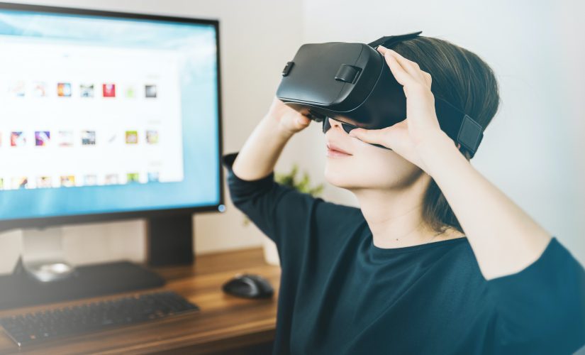 women with headset on in front of computer; new web 3D